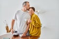 husband kissing head of cheerful wife