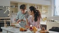 Husband kissing wife goodbye going on work. Happy couple drinking coffee kitchen Royalty Free Stock Photo