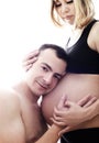 Husband listening the belly of his pregnant asian wife isolated on white background