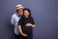 Husband and pregnant wife both take a look at their baby inside the belly