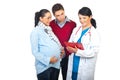 Husband and pregnant wife at doctor