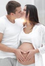 Husband and pregnant wife with folded hands in the shape of a heart on his tummy Royalty Free Stock Photo