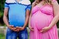 Husband and pregnant wife keep both with their big stomaches Royalty Free Stock Photo