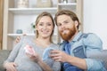 husband and pregnant woman looking at baby accessories Royalty Free Stock Photo