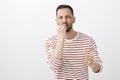 Husband preparing dinner for loving wife. Portrait of joyful handsome mature male with beard, kissing fingers while Royalty Free Stock Photo