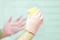 Husband with a scouring sponge cleaning the bathroom seat doing some housework. Royalty Free Stock Photo