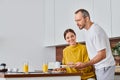 husband serving delicious breakfast near pleased