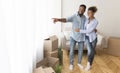 Husband Showing Wife View From Window Standing In New Home