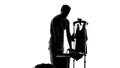 Husband silhouette in apron feeling tired of ironing clothes, housework routine
