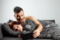 Husband spies on his wife`s phone while she sleeps. The concept of distrust, betrayal, jealousy, relationships, problems Royalty Free Stock Photo