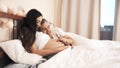 Husband stroking pregnant wife`s belly in bed Royalty Free Stock Photo