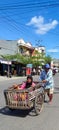 A husband transports his wife on a cart in Bulukumba, Indonesia