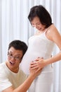 Husband try to hear fetus sound Royalty Free Stock Photo