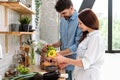 Husband unpacking shopping bag, wife help man putting vegetables on table Royalty Free Stock Photo