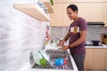 Husband washing dish in the kitchen sink Royalty Free Stock Photo