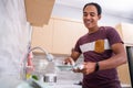 Husband washing dish in the kitchen sink Royalty Free Stock Photo