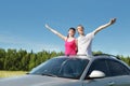 Husband, wife arrange hands in hatch of car