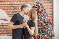 Cheers! Two people holding glasses of shampagne on Christmas. Couple celebrate New Year together Royalty Free Stock Photo