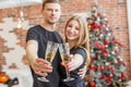 Cheers! Two people holding glasses of shampagne on Christmas. Couple celebrate New Year together Royalty Free Stock Photo