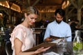 Husband and wife choosing food from menu. Happy loving couple at date in restaurant. Royalty Free Stock Photo