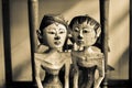 Old vintage traditional wooden statues of husband and wife with local custom fashion