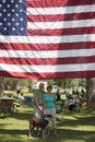 Husband, wife and dog under US Flag