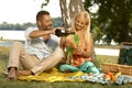 Husband and wife drinking champagne at picnic Royalty Free Stock Photo