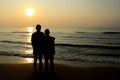 Husband and wife embracing at sea, silhouette