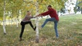 Husband and wife have fun in park among birch. Concept of seasoned love
