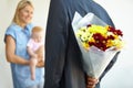 Husband, wife and hiding flowers for surprise, excited and happy with baby, love and appreciation. Bouquet, romance and