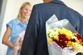 Husband, wife and hiding flowers for surprise, smile and happiness with baby, love and appreciation. Bouquet, romance
