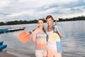 Husband and wife holding paddles while getting ready for river trip Royalty Free Stock Photo