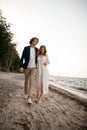 Husband and wife hug tightly while walking along the sea coast Royalty Free Stock Photo