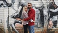 Husband and wife hugging on grafitty background. Concept of seasoned love Royalty Free Stock Photo