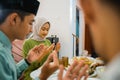 husband and wife pray before meals when breaking the fast Royalty Free Stock Photo