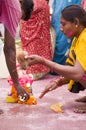 Husband wife praying before ganesha visarjan