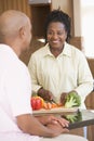 Husband And Wife Preparing A Meal Together