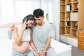 Husband wife sat on bed, pregnant wife, sit answer phone call from doctor, tense expression, husband pulled wife into embrace, two Royalty Free Stock Photo