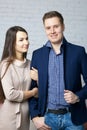 Husband and wife on the set in the studio. The wife with tenderness holds her husband`s arm. A husband with a pleased look is