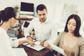 Husband and Wife Signing Documents with Lawyer.