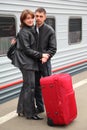 Husband and wife stand on perron near train