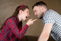 Husband and wife swear. Wife chastises husband for something, pointing finger