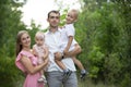 Husband and wife and their little children. Family portrait in nature Royalty Free Stock Photo