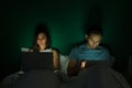 Husband and wife using laptops in bed Royalty Free Stock Photo