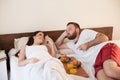 Husband and wife wake up in the morning in the bedroom weekend breakfast in bed Royalty Free Stock Photo