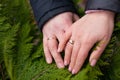 husband and wife wedding rings on hands