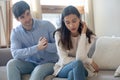 Husband of young woman clasping hands asking forgiveness after quarrel Royalty Free Stock Photo