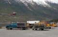 Sled dogs and apparatus waiting to be transported to a glacier for the summer tourist season