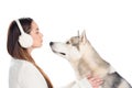 husky dog and beautiful woman in winter earmuffs Royalty Free Stock Photo