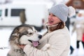 Husky dog hugs with adult woman. Winter outdoor walking - Reshetiha, Russia - 02.02.2019
